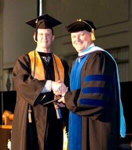 TCL Student of the Year Jonathan Bryant, left, is congratulated by TCL President Dr. Richard Gough at TCL’s 2014 Commencement Ceremony.