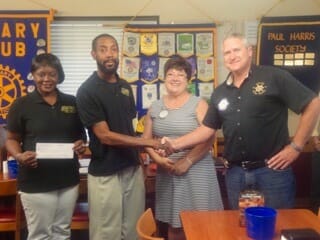 The Rotary Club of the Lowcountry President Alan Beach (far right) and Past President Charlotte Gonzalez (second from right) present brother and sister business owners Melissa and Charles Jones, of Jones Boxing Academy, with a check of support. Charles Jones said the money will help offset travel and food expenses when his boxers compete around the state and throughout the Southeast region. Jones Boxing Academy is located on Eastern Road in Beaufort and trains boxers from all over Beaufort County.