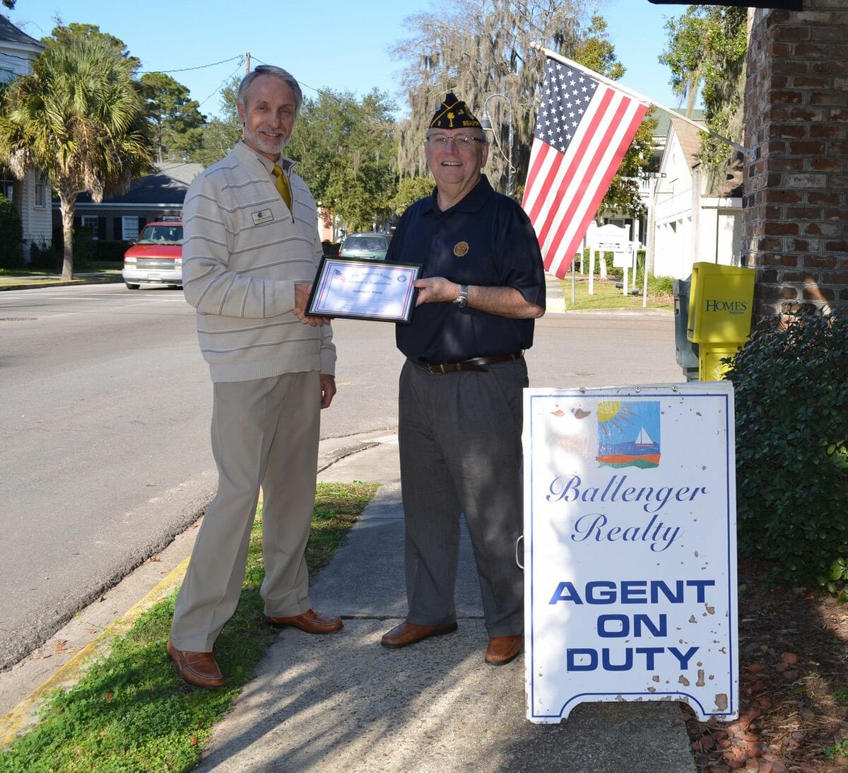 American Legion Post 9 Commander Chuck Lurey presents Everett Ballenger a certificate of appreciation to recognize local businesses that display the American flag.