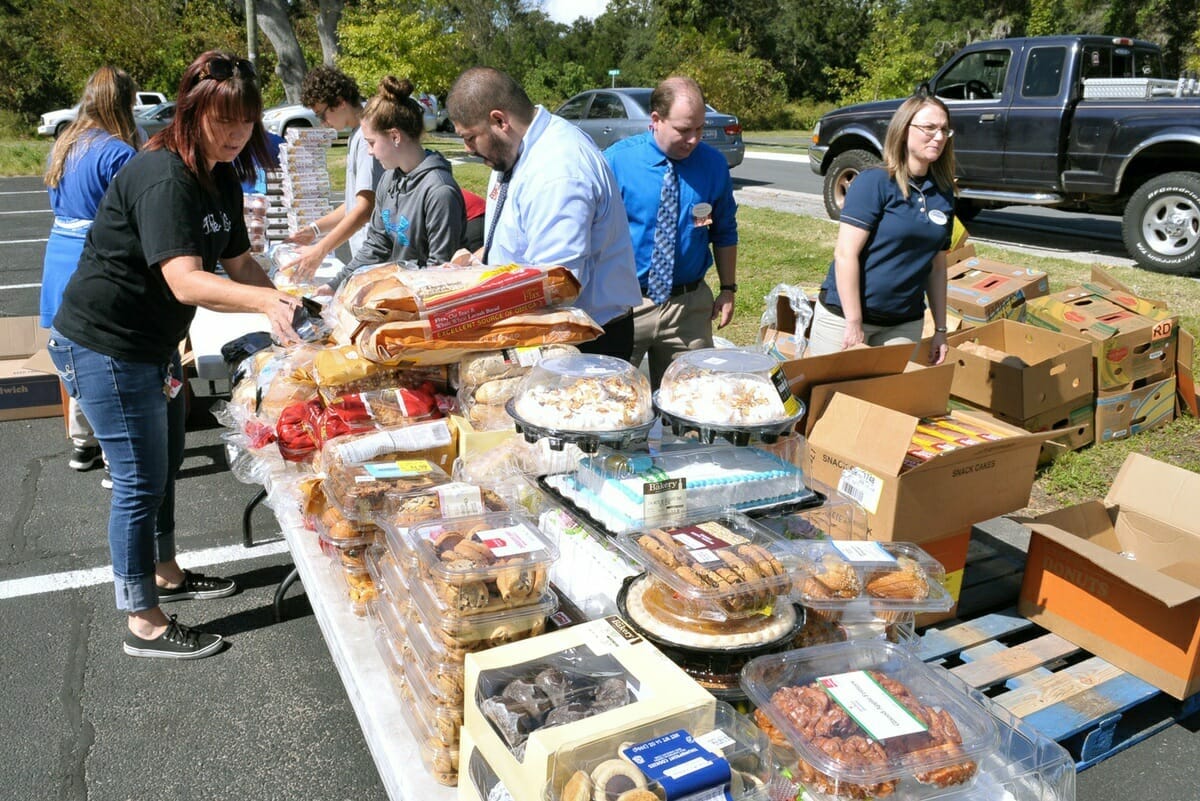 Some of the food items being given away included cakes, pies, pastries, water and fresh fruit and vegetables. Photo by Bob Sofaly.
