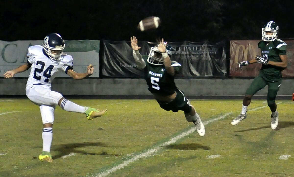 Beaufort’s Jeffrey Smyth, center, just misses blocking Stall’s punt during the first quarter Friday night at Eagle Stadium. The Eagles won the game 60-7. Photo by Bob Sofaly.