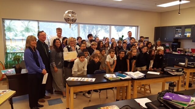 Jan Davis-Vater, of the Foundation for Educational Excellence, John Mosca, of the Foundation for Educational Excellence and Okatie Rotary, and Bell Beltz, of the Okatie Rotary, surprise River Ridge Academy teachers Jennifer Bell and Chandra Payne and their students with a grant for a study of bones and vertebrae. River Ridge Academy Assistant Principal Matt Hall helped gather the group for the grant presentation.