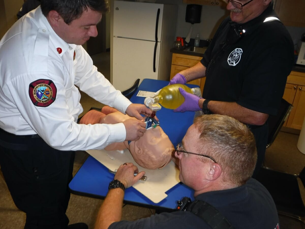 Burton Lt. John Ireland instructs Lt. Alex Murray and firefighters on providing advanced airway techniques and respirations to a patient in cardiac arrest. 