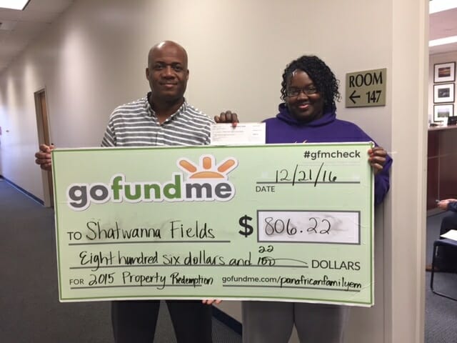 PAFEN First Vice Chair Stephen A. MaHayle, of Jamaica, left, presents an $806.22 gofundme check to Grays Hill resident Shatwanna Fields to redeem her mobile home lot, which was sold at the 2015 Beaufort County Delinquent Tax Sale. A guaranteed funds payment was submitted to the Beaufort County Treasurer's Office on Fields' behalf. Fields was among the Gullah-Geechee families who received more than $10,000 in property tax assistance from the PAFEN in 2016.