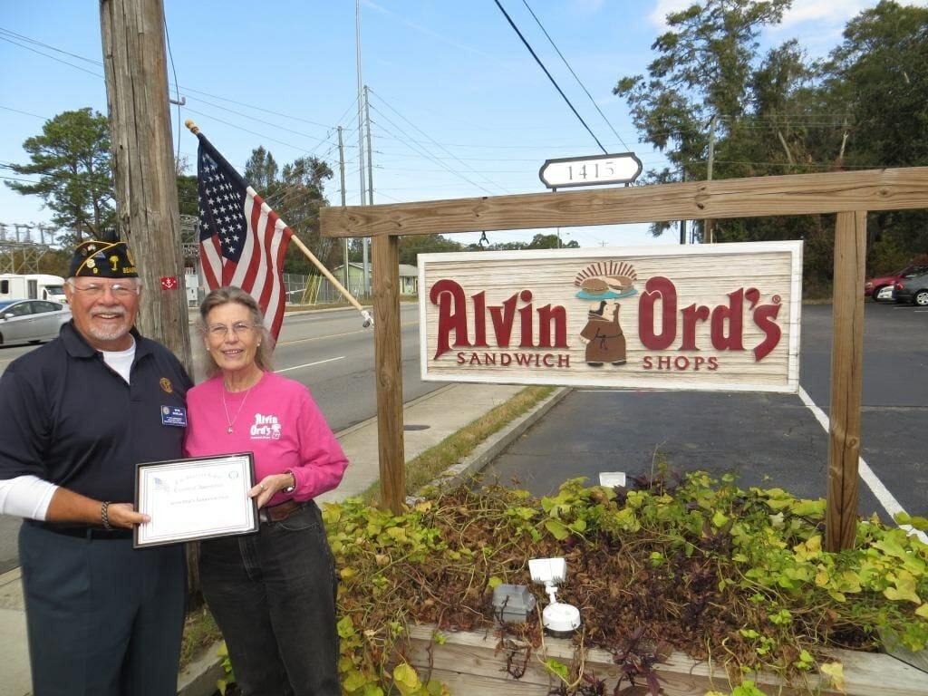 American Legion Beaufort Post 9 is striving to promote both patriotism and businesses in the Beaufort area by calling attention to those that proudly display the U.S. flag at their location. Post 9 presents those enterprises with a framed certificate thanking them. Here 1st Vice Commander Bob Shields thanks Marie Lewis, owner of Alvin Ord's Sandwich Shop, for showing the flag.