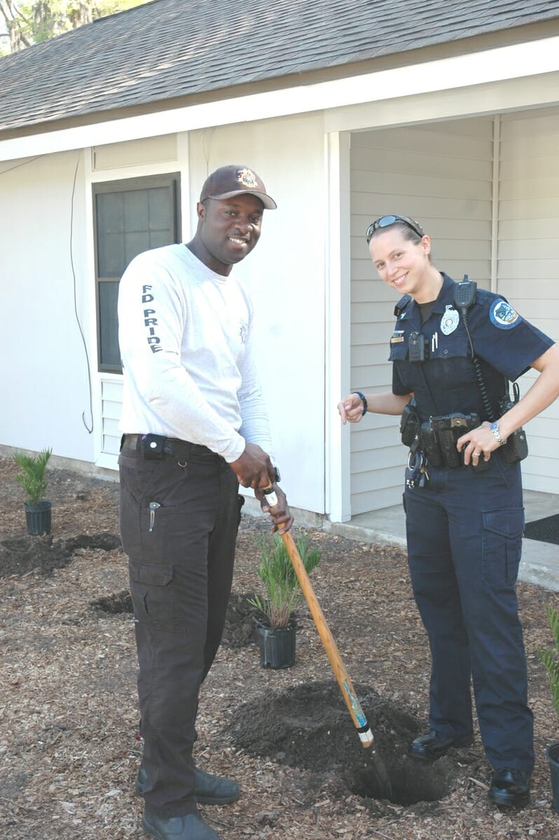 Police and fire volunteers help with the plantings on Duke Street on March 27. Photo provided.
