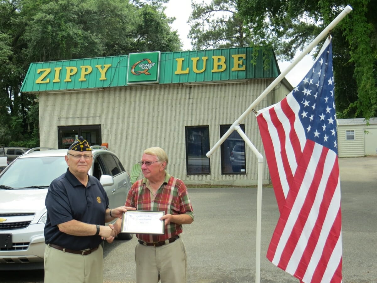 American Legion Beaufort Post 9 is striving to promote both patriotism and businesses in the Beaufort area by calling attention to those that proudly display the U.S. flag at their location. Post 9 presents those enterprises with a framed certificate thanking them. Above, Post 9 Commander Chuck Lurey presents Larry Kizer of Zippy Lube with his certificate.