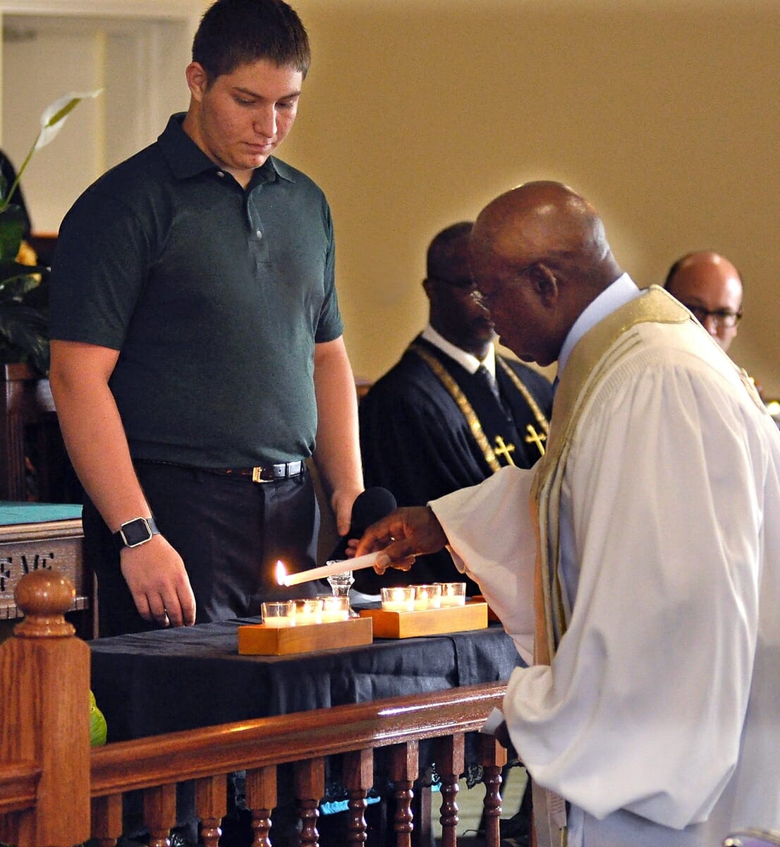 The Rev. Arthur Cummings, right, president of the Beaufort County Ministerial Alliance, lights the last candle on June 16 in memory of the “Emanuel Nine” who were murdered two years ago while attending Emanuel AME Church in Charleston. The candles were part of the Evening of Remembrance Memorial Candlelight Service sponsored by the Unified Interfaith Community Coalition of Beaufort at Grace Chapel AME Church on Lady’s Island. 