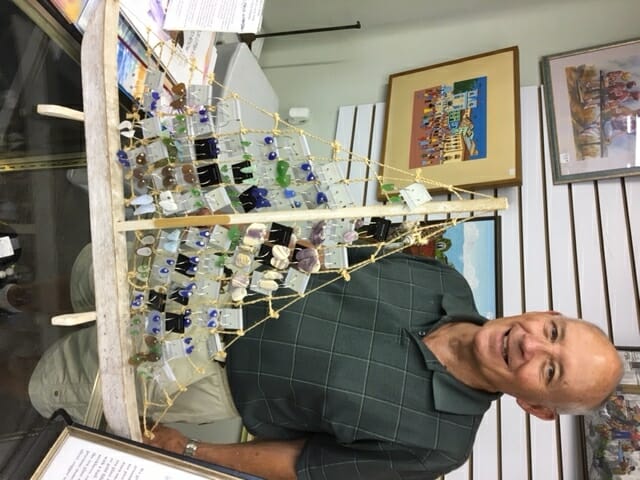 The 2or3 Treasure House is marking its first anniversary with a weeklong, storewide sale, which will include jewelry shown here by manager Gordon Mabie. Photo provided.
