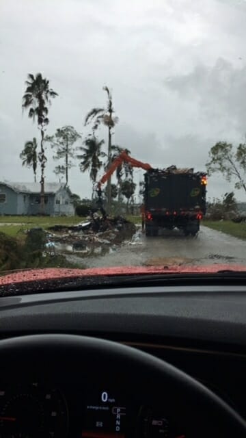 The guys with the big black trucks and trailers and claw arms are independent contractors who are known by the insiders as “storm chasers.” Because of the destruction wrought by Hurricane Harvey there are fewer of them to go around to gather up the debris left behind by Irma and Nate. Accordingly, the clean-ups for those hurricanes will be slower than usual. Photo provided.