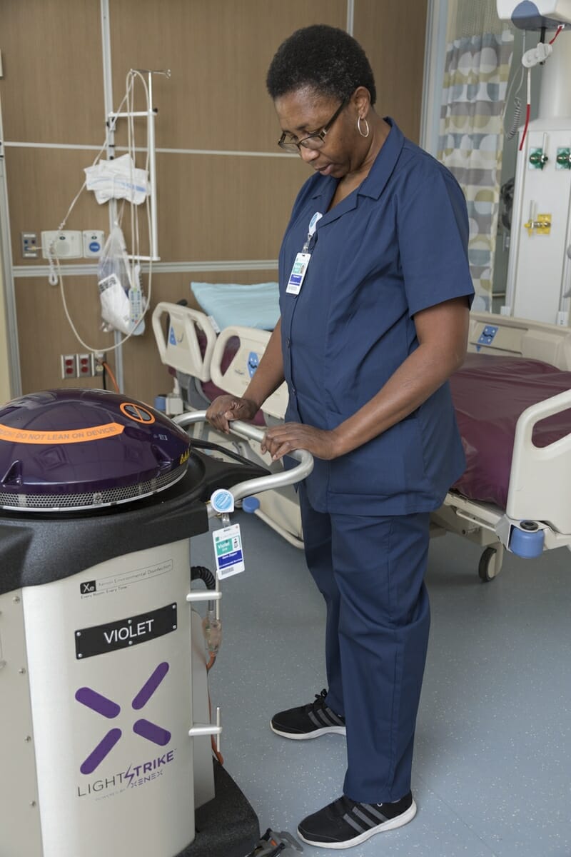 BMH technician Birdie Wright is shown here with the portable robot, nicknamed Violet by the staff, that kills antibiotic-resistant germs using high-intensity, pulsed ultraviolet light. Photo by Paul Nurnberg.